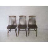 Three mid century Ercol style stick back chairs.