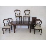 A Victorian style oval extending dining table, along with a set of 6 balloon back chairs.