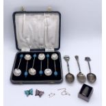 A set of silver plated coffee bean spoons along with three silver coffee spoons, two enamelled