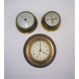 Two wall clocks, along with a barometer.