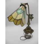 An antique style adjustable desk lamp with Tiffany style shade
