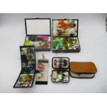 A collection of fishing flies and lures in storage cases, along with Scierra carry bag