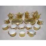 A Royal Worcester gold coloured part tea and coffee set including 6 cups, tea pots, coffee pots,