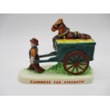 A vintage Carlton Ware ceramic Guinness figurine depicting a Drayman pulling a cart with a