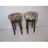 A pair of upholstered oak stools.