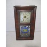 An American wall clock by the Waterbury Clock Company. 76cm x 42cm