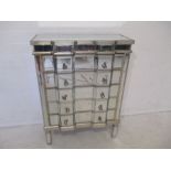 A mirrored chest of five drawers, length 82cm, height 112cm.