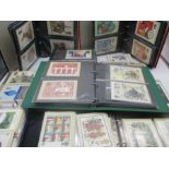 A large collection of stamp postcards spread over several albums.