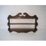 An oak 3 tier wall hanging shelf, with carved decoration, marked 'THS 1915'.