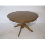 A modern oak circular dining table
