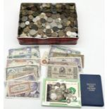A collection of coins and banknotes including some silver