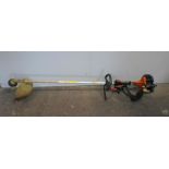 A Tanaka TBC-230S petrol strimmer along with two blades, strimming line and manual etc