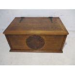 A metal bound oak box, with carved decoration.