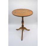 An antique burr elm occasional table, on turned tripod base, A/F.