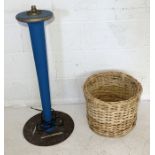 A handmade wooden standing lamp along with a wicker basket