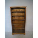 A pine freestanding bookshelf, length 89cm, height 176cm.