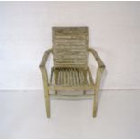 A weathered wooden garden arm chair.