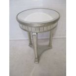 A circular mirrored drum table.