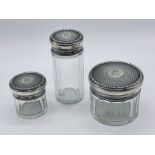 Three silver topped dressing table pots