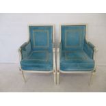 A pair of Julian Chichester designer armchairs, with white painted frames and turquoise upholstery.