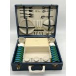 A 1950's Sirram picnic basket with a complete with plates, knives, forks, Aladdin flasks etc