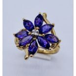 A 9ct gold amethyst and diamond flower shaped ring