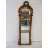 An ornate gilt framed wall mirror, height 145cm.