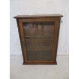 A wall hanging oak glazed display cabinet, length 57cm, height 75cm.