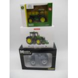 A collection of three boxed die-cast tractors including a Marge Models New Holland, Wiking John