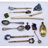 A collection of bone bobbins with coloured beads, two silver coffee spoons, badge, brooch etc.