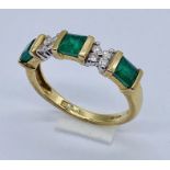 An emerald and diamond ring set in 9ct gold