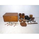 A wooden box, containing an assortment of wooden items, including goblets, elephants, an Oriental
