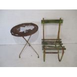A metal framed garden chair and table, as found.