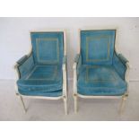 A pair of Julian Chichester designer arm chairs, with white painted frames and turquoise upholstery.