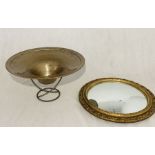 A circular gilt framed mirror along with a large metal bowl on stand