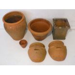 A quantity of various sized terracotta garden pots.