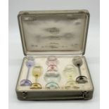A cased set of coloured miniature Moser Physiognomical Snifters for the Moser Club to comprise Stout