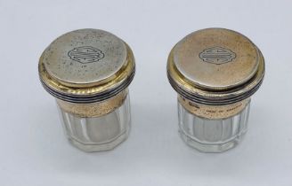 A pair of Asprey silver topped dressing table pots