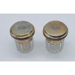 A pair of Asprey silver topped dressing table pots