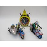 Two reproduction tinplate wind-up motorbikes, one with side car, along with a vintage German