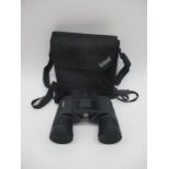A pair of Bushell binoculars in carry bag
