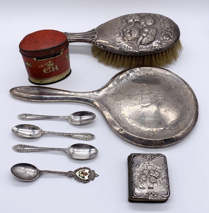 A small collection of hallmarked silver items including brush and mirror, coffee spoons and a common