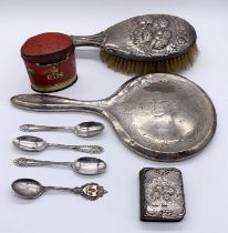 A small collection of hallmarked silver items including brush and mirror, coffee spoons and a common