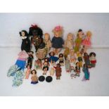 A collection of various vintage dolls, contained within a suitcase.