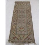 A cream ground rug with geometric patterns