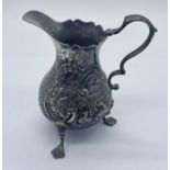 A hallmarked silver cream jug with embossed detailing, weight 71.3g