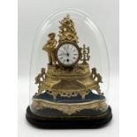 A Victorian gilt metal clock beneath glass dome (glass A/F) height