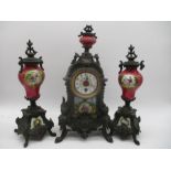 A turn of the century French clock garniture with hand painted porcelain panels