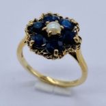 A 9ct gold cluster ring set with sapphires and a seed pearl