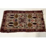 An Eastern red ground woven rug